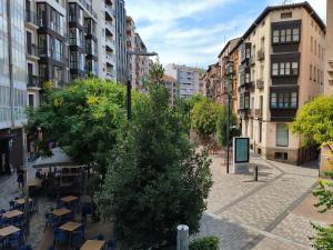 a city street with tables and chairs and buildings at A un paso de Laurel Estudio con balcón in Logroño