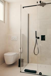 a bathroom with a glass shower with a toilet at B&B Inn Between in Ghent +14 photos