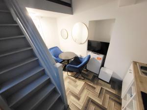 a staircase with blue chairs and a table in a room at Historic Loft in Cork in Cork