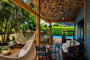 a hammock on the porch of a house at Pousada Mar Aberto in Fernando de Noronha