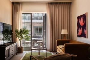 a living room with a couch and a table at The Nickel Hotel in Charleston