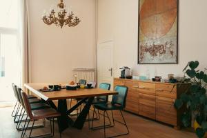 a dining room table with chairs and a chandelier at B&B Inn Between in Ghent