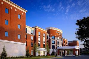 a large red brick building next to a street at Courtyard by Marriott Memphis Collierville in Collierville