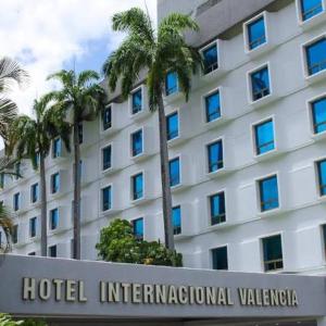a hotel international valencia with palm trees in front of it at Hotel & Casino Internacional Valencia in Valencia