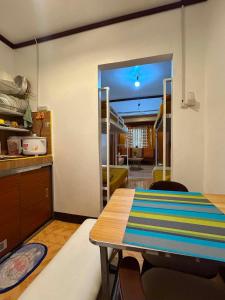 a dining room with a table and a view of a kitchen at Tiny house studio near SM City Daet in Daet +4 photos
