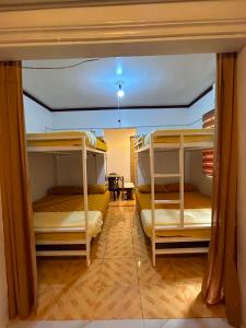a room with three bunk beds and a table at Tiny house studio near SM City Daet in Daet