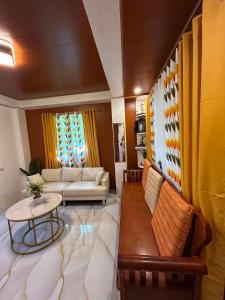 a living room with a couch and a table at Tiny house studio near SM City Daet in Daet