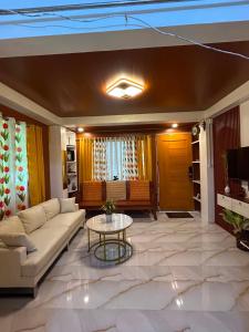 a living room with a couch and a table at Tiny house studio near SM City Daet in Daet