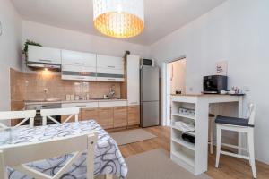 a kitchen and dining room with a table and a refrigerator at Guest house Bella in Slatine