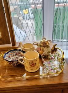 a tray with cups and a tea set on a table at Cornerstone Budget in Ashford