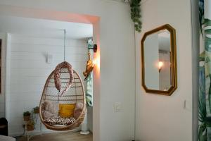 a room with a hanging chair and a mirror at Escapade tropicale au Costa Rica in Profondeville +33 photos