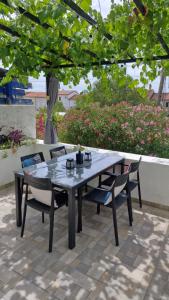 a table and chairs sitting on a patio at Apartman Mocic in Punat