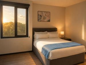 a bedroom with a bed and a window at Grand Resort & Residences in Belize City +49 photos