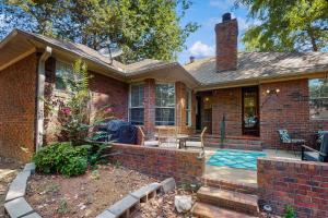 a brick house with a pool in the yard at <1 Block to Trails! Conway Biker & Hikers Haven in Conway
