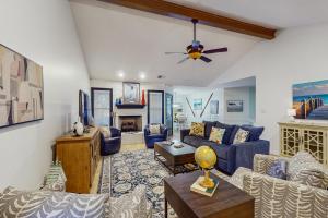 a living room with blue furniture and a ceiling fan at <1 Block to Trails! Conway Biker & Hikers Haven in Conway