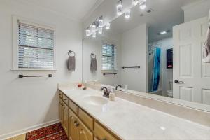 a bathroom with a sink and a large mirror at <1 Block to Trails! Conway Biker & Hikers Haven in Conway +16 photos
