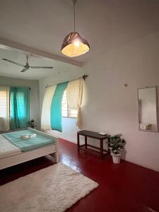 a room with a bed and a table and a window at Peponi Watamu in Watamu +74 photos