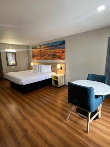 a hotel room with a bed and a table at Days Inn by Wyndham Payson in Payson