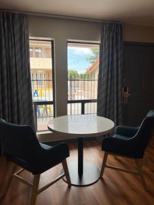 a table and chairs in a room with a window at Days Inn by Wyndham Payson in Payson