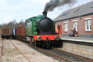 a steam engine train pulling into a train station at Goosemoor Cottage in Longdon