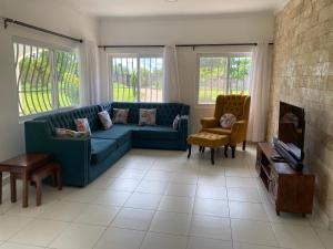 a living room with a blue couch and a fireplace at Nyumba Nzuri in Ukunda, Diani in Ukunda