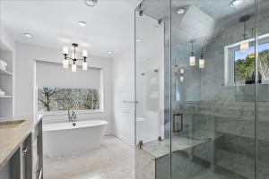 a bathroom with a shower and a tub and a sink at Stowestruck in Stowe