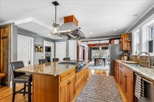 a kitchen with wooden cabinets and a large island at Stowestruck in Stowe