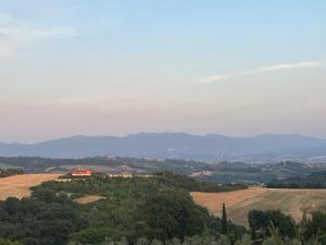 a view of a farm with a house on a hill at L'Uggetto in Montecastrilli