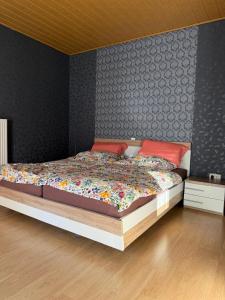 a bedroom with a large bed with red pillows at Wohnen nahe der Ems in Fresenburg