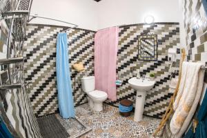 a small bathroom with a toilet and a sink at Riad Chada Fez in Fez +64 photos