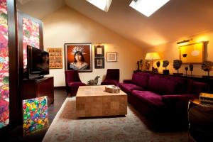 a living room with a couch and a table at The Vagabond Club, a Tribute Portfolio Hotel Singapore in Singapore