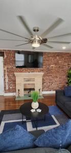 a living room with a table and a fireplace at Xscapecation Oasis III in Tulsa