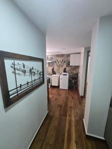 a living room with a picture on the wall at Apartamento quarto e sala em campo grande in Cariacica
