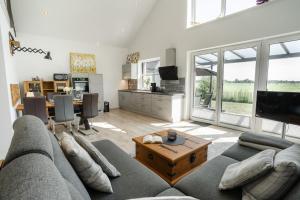 a living room with a couch and a table at Haus Weitwinkel in Sehestedt