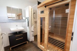 a bathroom with a sink and a shower at Haus Weitwinkel in Sehestedt +47 photos