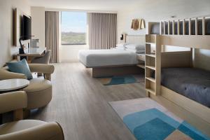 a hotel room with a bedroom with a bed and a desk at Toronto Airport Marriott Hotel in Toronto +114 photos