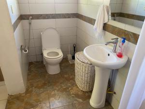 a bathroom with a toilet and a sink at Nyumba Nzuri in Ukunda, Diani in Ukunda +29 photos