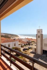 a balcony with a view of the beach and buildings at Hotel Miramar - São Pedro de Moel in São Pedro de Moel