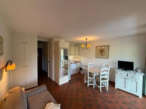 a living room and kitchen with a table and chairs at Apparthotel Saint Tropez centre in Saint-Tropez