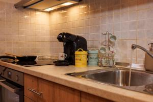 a kitchen counter with a sink and a stove at Linas Concept in Fourfourás +15 photos