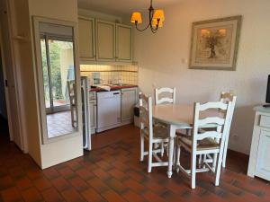 a kitchen with a table and chairs in a kitchen at Apparthotel Saint Tropez centre in Saint-Tropez +4 photos