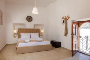 a bedroom with a bed and a clock on the wall at Linas Concept in Fourfourás