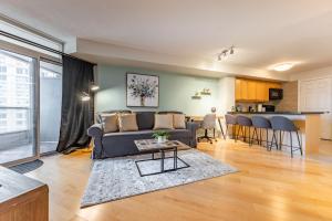 a living room with a couch and a table at Designer Apartment in Prime Location in Mississauga