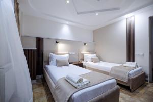a hotel room with two beds and a couch at Time Stay Hotel in Yerevan +19 photos
