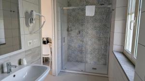 a bathroom with a shower and a sink at Agrialbergo Capalbio La Sugherella - Hotel Il Cipresso in Capalbio +68 photos