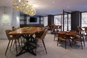 a dining room with tables and chairs and a chandelier at Toronto Airport Marriott Hotel in Toronto
