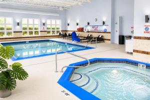a pool in a large room with a swimming pool at Holiday Inn Express Wixom by IHG in Wixom