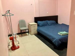 a bedroom with a bed and a chair and a desk at Arecrata in Phnom Penh +13 photos