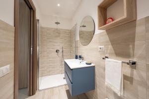 a bathroom with a sink and a shower at Raggio di Sole Ulassai in Ulassai +39 photos
