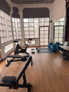 a gym with some exercise equipment in a room with windows at Hotel Residencial in Mérida